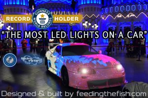 World record breaking LED card pink. Text on the image reads: World record holder. Most LED lights on a Car. Designed and build by Feeding the Fish.